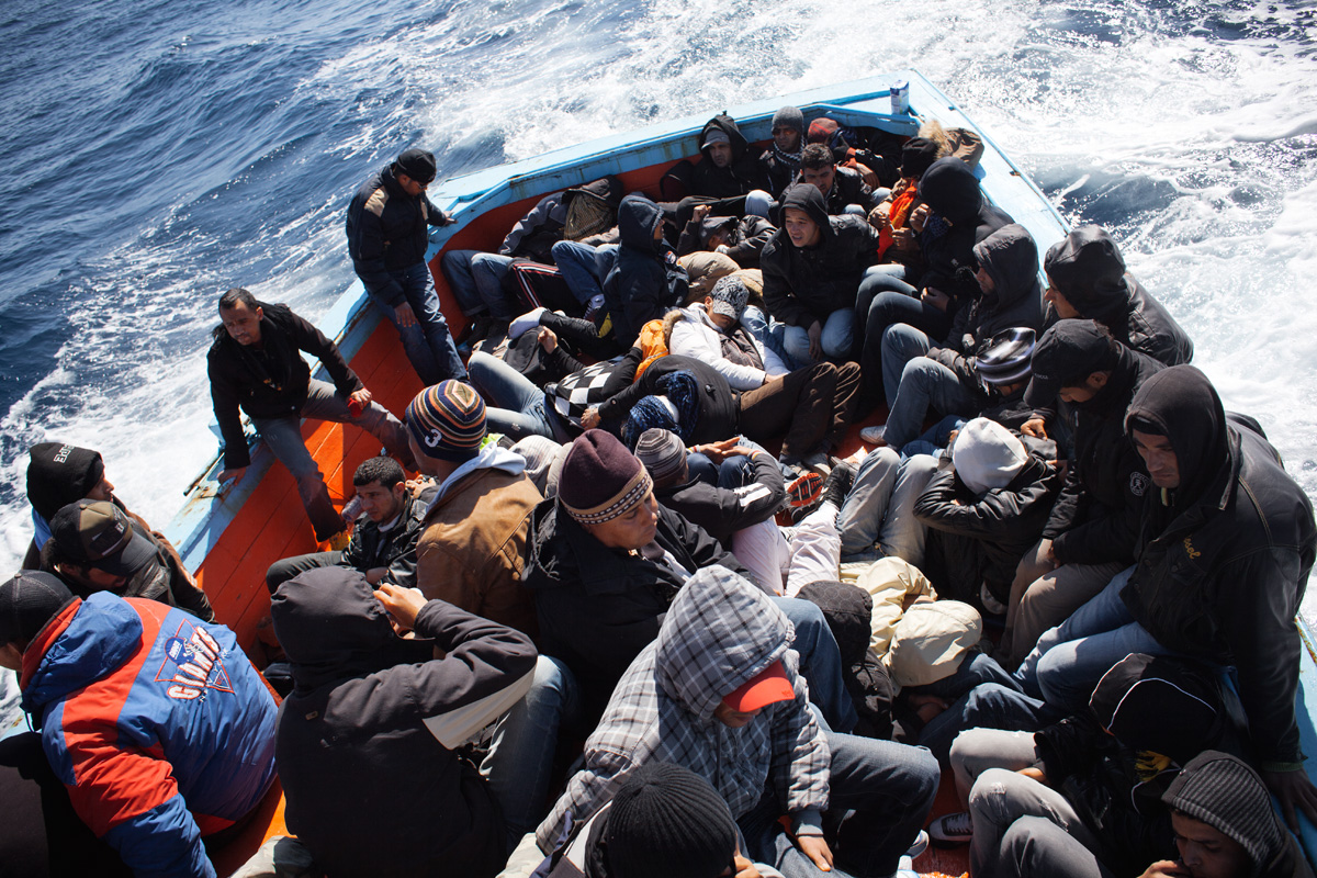 The swell makes people seasick. For most of the Tunisians in the boat, this is their first time at sea.