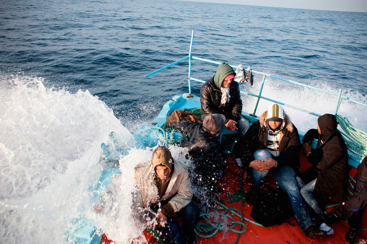 The leaky boat is taking in water on all sides. Passengers are freezing cold.