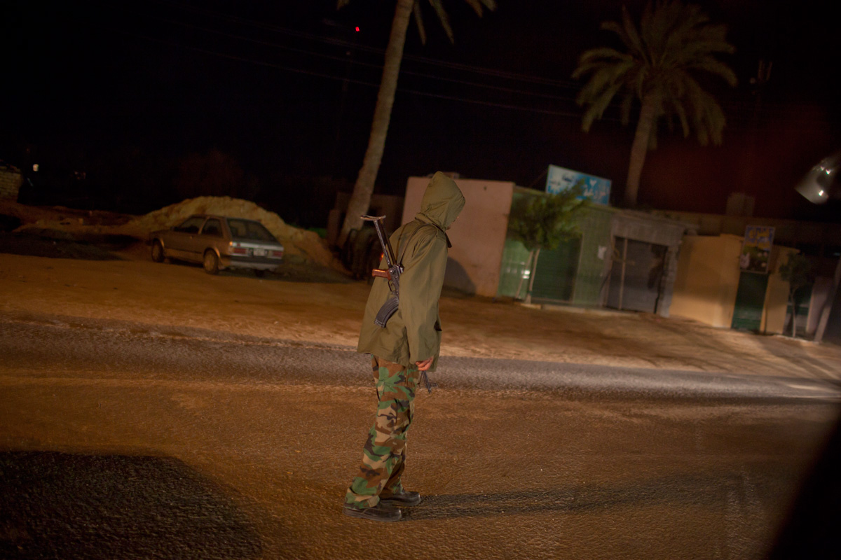 To leave the country, we are brought to the Tunisian border under heavy guard. Our bus is forced to bypass the opposition-held town of Zawiyah.

