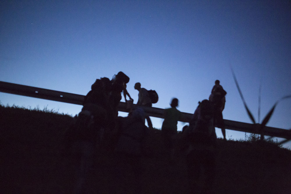 The group avoids walking on the roads not to be seen by soldiers and police. 
Border between Serbia and Hungary. July 15, 2015.