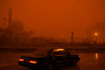 March 27th  2003.
 Saddam Hussein statue in central Baghdad under sandstorm.

