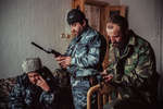 December 13th 1999.
 Amir Khattab (on a mobile telephone), wearing the typical astrakhan hat of the region; Commandant Sayed and Shirvani Baseyev, brother of Shamil, checking their mobile phones.

